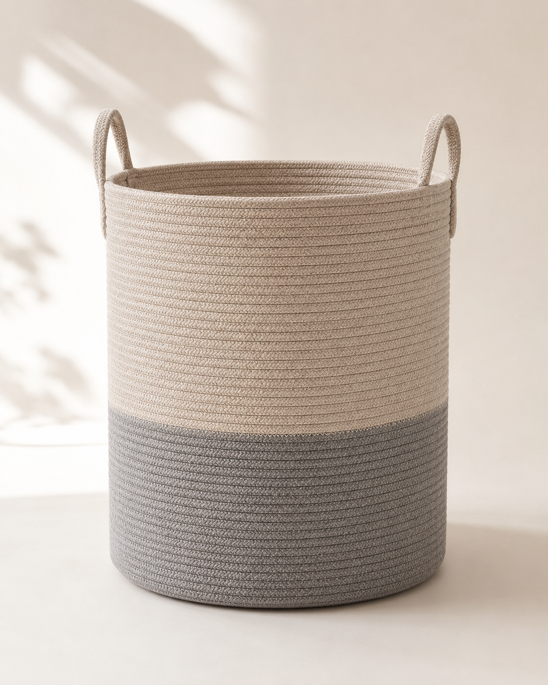 The LIND Carry Basket styled in a neutral laundry room, holding folded laundry